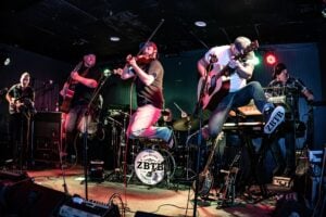 Zac Brown Tribute Band performing energetically on stage.
