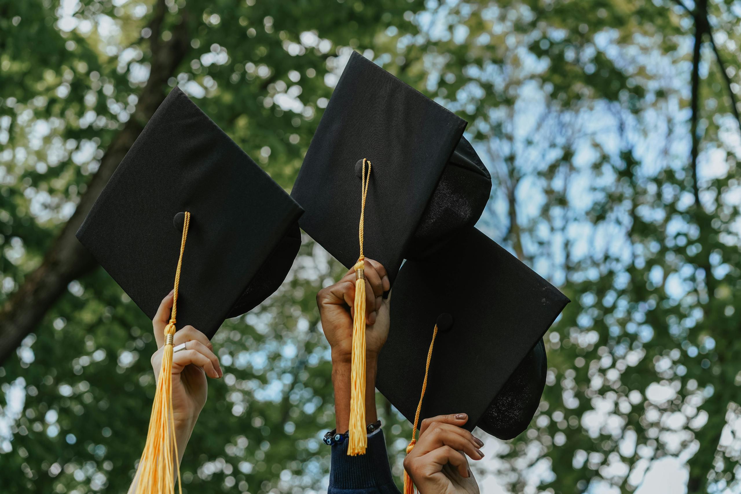 graduation weekend caps in hand